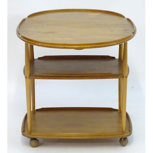 1236 - Vintage Retro, Mid-Century: an Ercol elm and beech three tiered trolley, the top with drop flaps, su... 