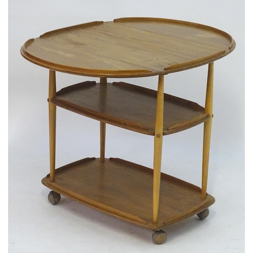 1236 - Vintage Retro, Mid-Century: an Ercol elm and beech three tiered trolley, the top with drop flaps, su... 