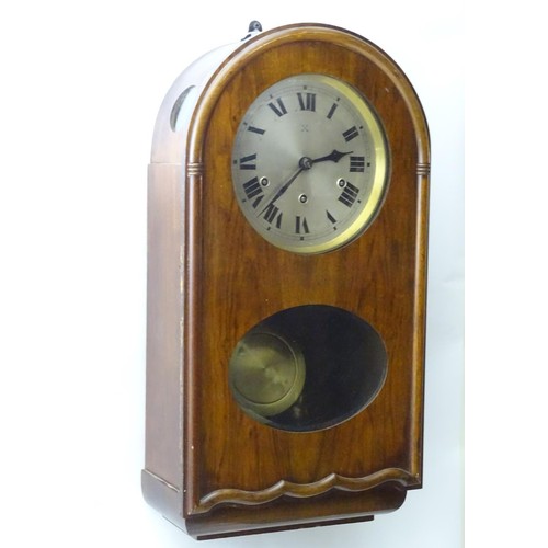 1184 - An early to mid 20thC wall clock, the arch top mahogany case with glazed sections, the 7