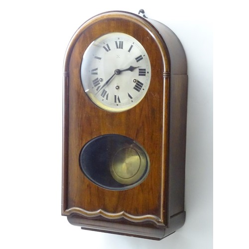 1184 - An early to mid 20thC wall clock, the arch top mahogany case with glazed sections, the 7