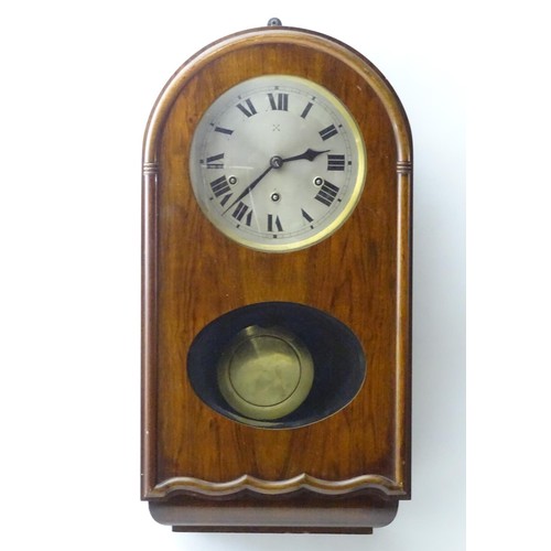 1184 - An early to mid 20thC wall clock, the arch top mahogany case with glazed sections, the 7