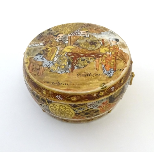 31 - A Japanese Satsuma pot and cover. The cover decorated with a landscape scene with two scholar figure... 