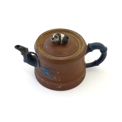 39 - A Chinese clay teapot, the handle and spout modelled as stylised bamboo, the lid surmounted by a rec... 