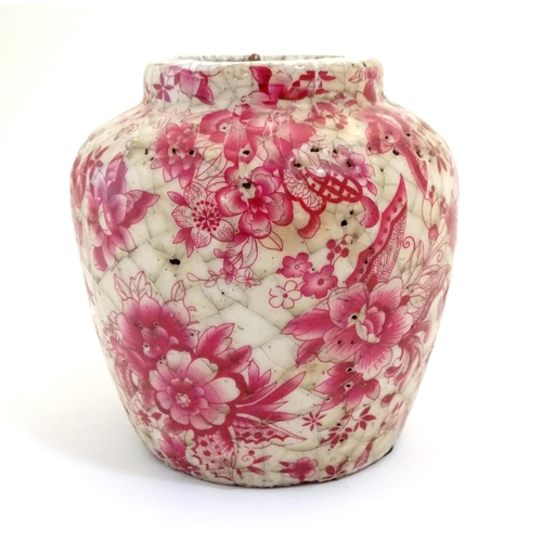 43 - A Continental squat vase with a pink flower and foliate detail and a crackle glaze. Approx. 5 3/4