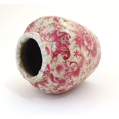 43 - A Continental squat vase with a pink flower and foliate detail and a crackle glaze. Approx. 5 3/4
