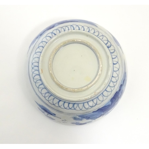 9 - A Chinese blue and white bowl with hand painted decoration depicting an Oriental landscape with pago... 