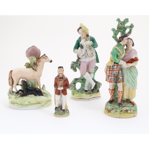 68 - Three assorted Staffordshire figures, comprising a bud vase with horse and foal, a highland couple a... 