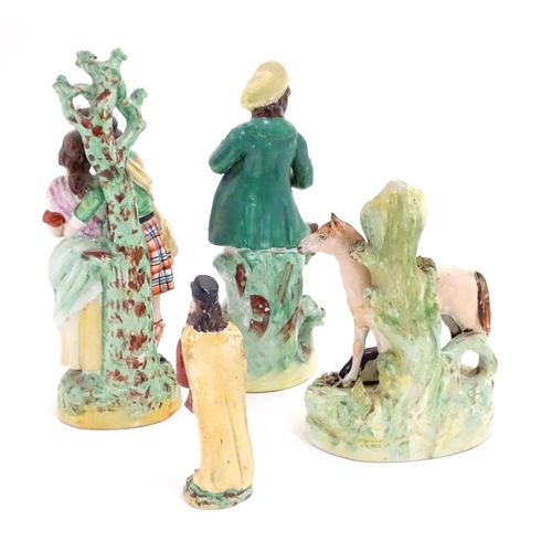 68 - Three assorted Staffordshire figures, comprising a bud vase with horse and foal, a highland couple a... 