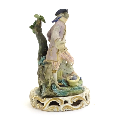 76 - A Continental porcelain figural group depicting a shoe shine girl shining a gentleman's shoes in a n... 