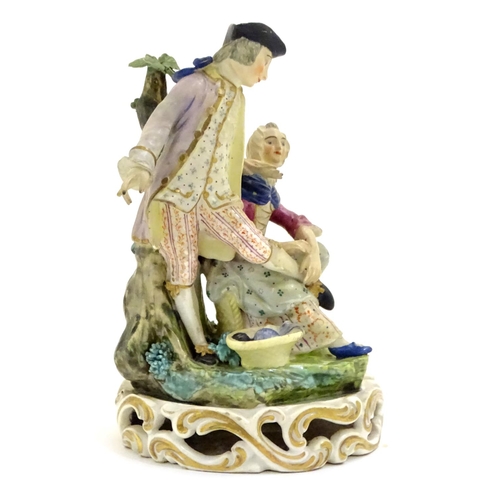 76 - A Continental porcelain figural group depicting a shoe shine girl shining a gentleman's shoes in a n... 