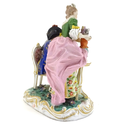 77 - A Continental porcelain figural group depicting a seated man playing a musical instrument and a lady... 