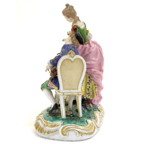 77 - A Continental porcelain figural group depicting a seated man playing a musical instrument and a lady... 