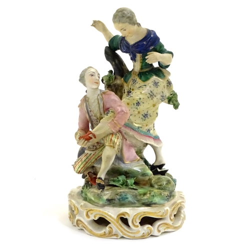 78 - A Continental porcelain figural group with two figures, a kneeling gentleman fitting a slipper on a ... 