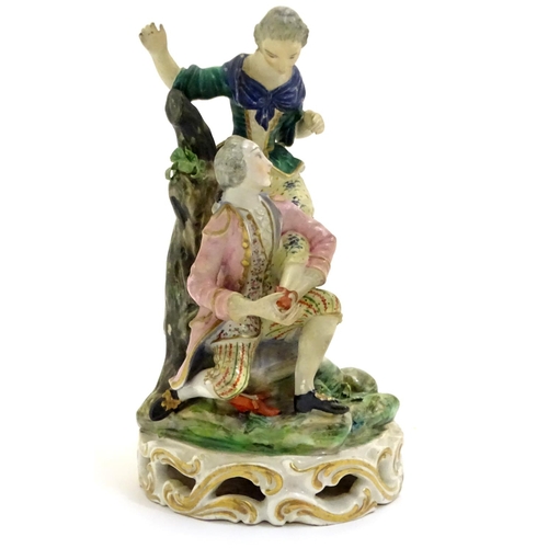 78 - A Continental porcelain figural group with two figures, a kneeling gentleman fitting a slipper on a ... 