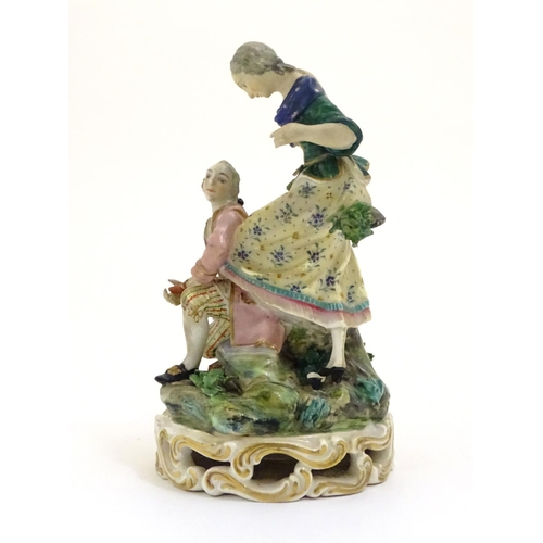 78 - A Continental porcelain figural group with two figures, a kneeling gentleman fitting a slipper on a ... 