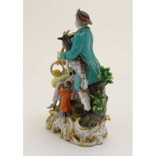 79 - A Continental porcelain figural group on a naturalistic base, depicting a gentleman holding a goat p... 