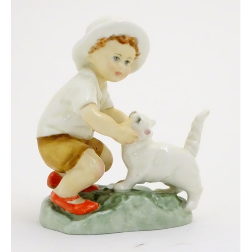 103 - A Royal Worcester figure, Snowy, modelled as a child with a white cat . Marked under with title, mod... 