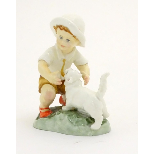 103 - A Royal Worcester figure, Snowy, modelled as a child with a white cat . Marked under with title, mod... 