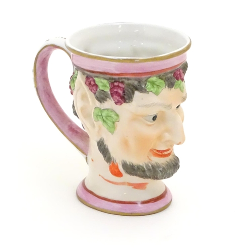 105 - A Victorian Staffordshire character mug modeled as Bacchus. Approx. 4