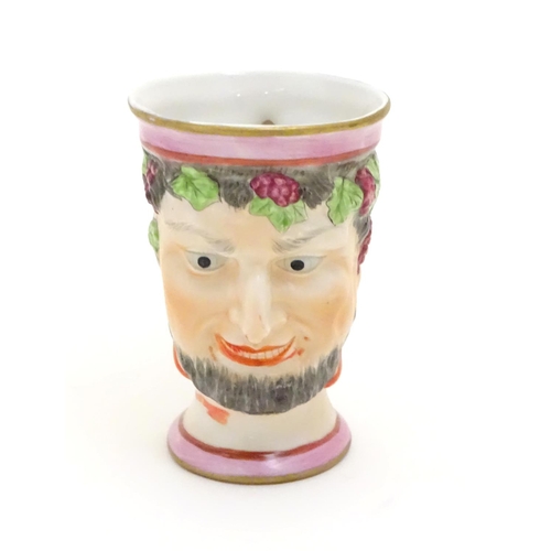 105 - A Victorian Staffordshire character mug modeled as Bacchus. Approx. 4