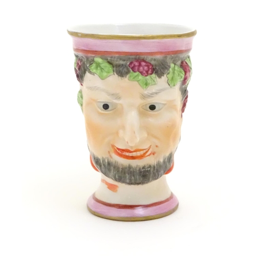 105 - A Victorian Staffordshire character mug modeled as Bacchus. Approx. 4