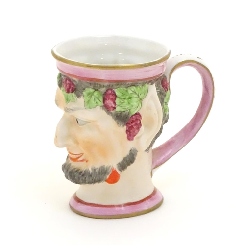 105 - A Victorian Staffordshire character mug modeled as Bacchus. Approx. 4