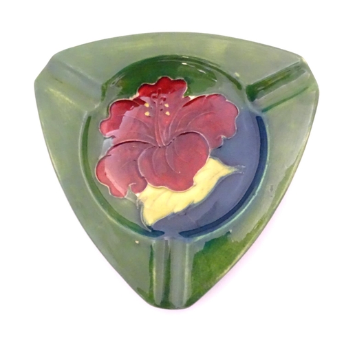 111 - A Moorcroft green ground pin dish / ashtray of triangular form in the Hibiscus pattern. Impressed ma... 