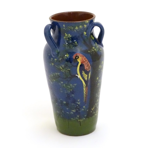 114 - A Longpark Torquay tyg vase with relief parrot decoration and hand painted landscape decoration with... 