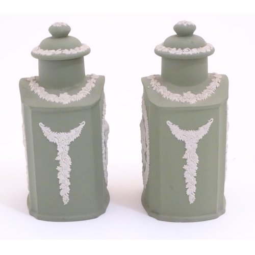 124 - A pair of Wedgwood sage green Jasperware tea caddies and covers, decorated with portrait medallions ... 