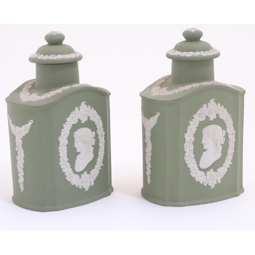 124 - A pair of Wedgwood sage green Jasperware tea caddies and covers, decorated with portrait medallions ... 