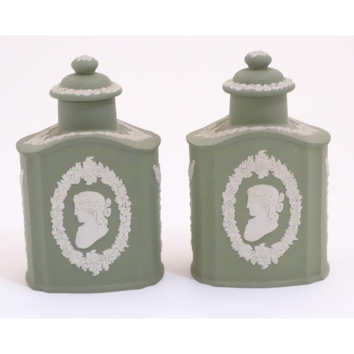 124 - A pair of Wedgwood sage green Jasperware tea caddies and covers, decorated with portrait medallions ... 