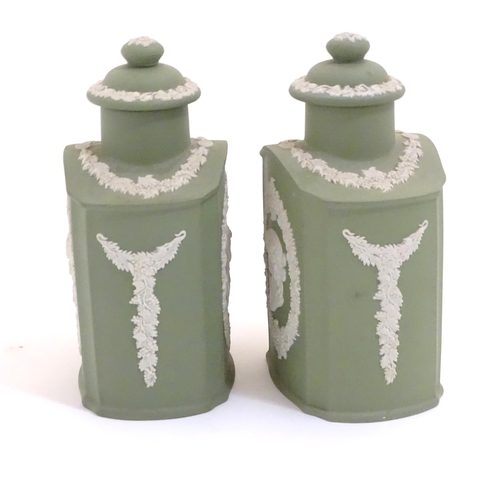 124 - A pair of Wedgwood sage green Jasperware tea caddies and covers, decorated with portrait medallions ... 