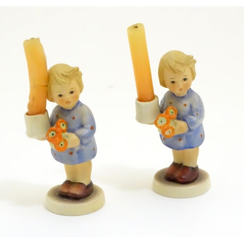 126 - A pair of Vintage Hummel candle holders, girl with candle, model no. #115 impressed to base
beside T... 