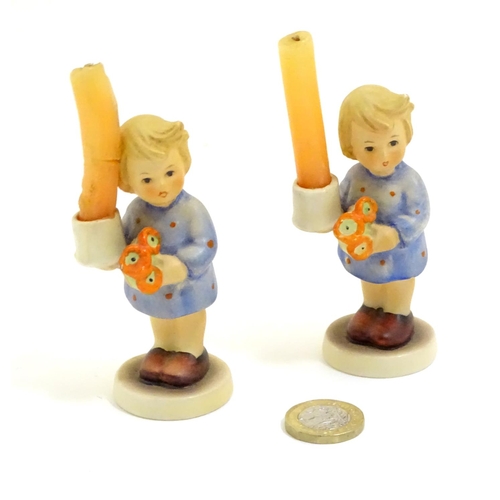 126 - A pair of Vintage Hummel candle holders, girl with candle, model no. #115 impressed to base
beside T... 