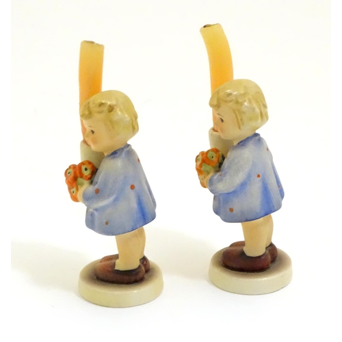 126 - A pair of Vintage Hummel candle holders, girl with candle, model no. #115 impressed to base
beside T... 