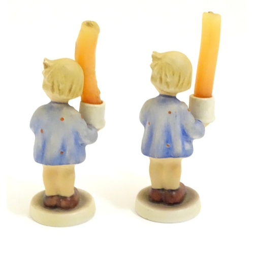 126 - A pair of Vintage Hummel candle holders, girl with candle, model no. #115 impressed to base
beside T... 