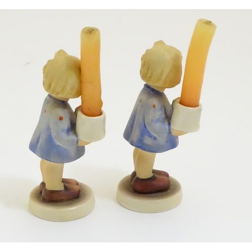 126 - A pair of Vintage Hummel candle holders, girl with candle, model no. #115 impressed to base
beside T... 