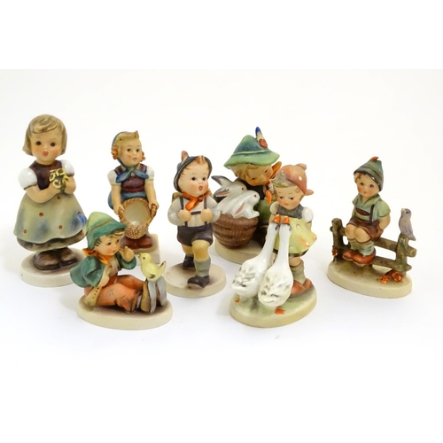 127 - A collection of seven vintage Hummel figurines, comprising #47 Goose Girl, #58/0 Playmates, #63 Sing... 