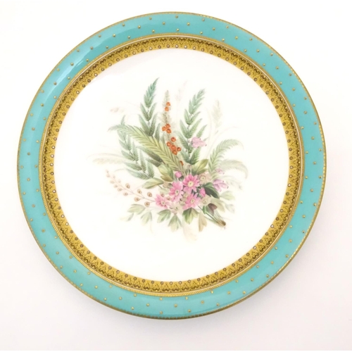 128 - A Worcester dessert plate with hand painted floral and foliate spray to centre, bordered in turquois... 