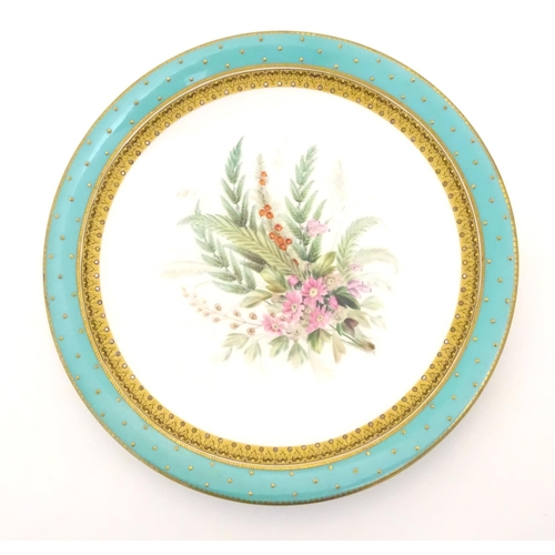 128 - A Worcester dessert plate with hand painted floral and foliate spray to centre, bordered in turquois... 