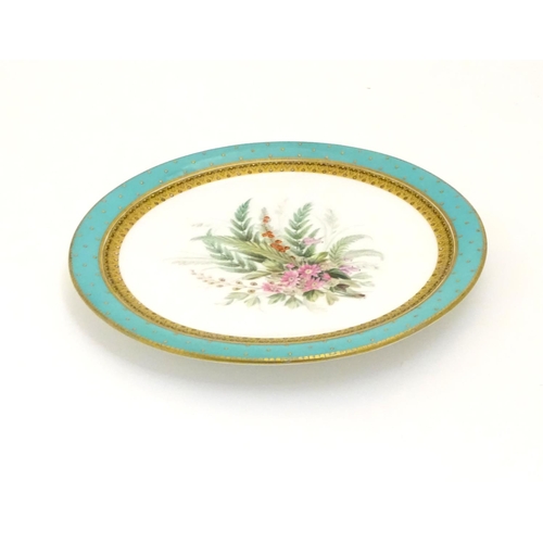 128 - A Worcester dessert plate with hand painted floral and foliate spray to centre, bordered in turquois... 