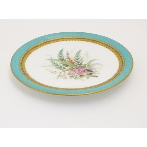 128 - A Worcester dessert plate with hand painted floral and foliate spray to centre, bordered in turquois... 