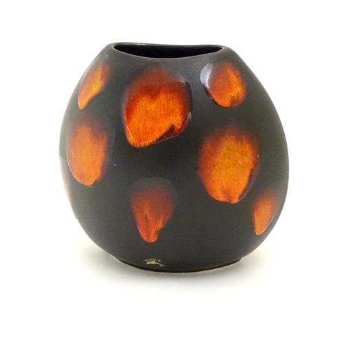 129 - A Poole Pottery purse vase in the living glaze galaxy pattern. Marked under. Approx. 7