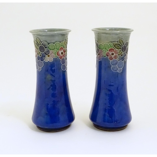 97 - A pair of Art Deco Royal Doulton blue glazed stoneware vases of cylindrical waisted form, decorated ... 