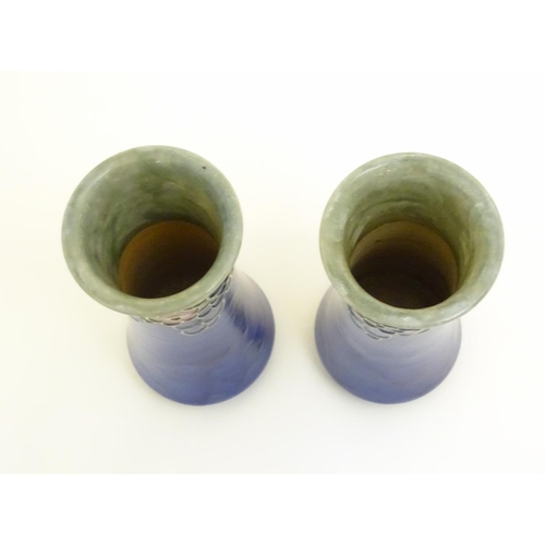 97 - A pair of Art Deco Royal Doulton blue glazed stoneware vases of cylindrical waisted form, decorated ... 