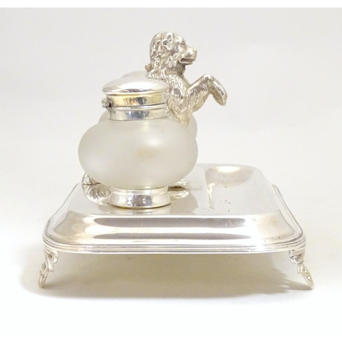 1007 - A silver plate desk standish with two glass inkwells and a model of a begging dog to centre. Approx.... 