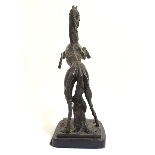 1022 - A 20thC bronze sculpture of a rearing horse on a rectangular base. Approx. 18