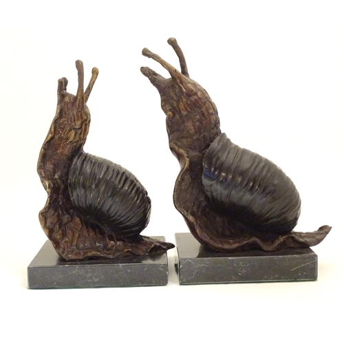 1029 - A pair of 20thC cast bronze bookends modelled as snails, each on a rectangular marble base. Approx. ... 