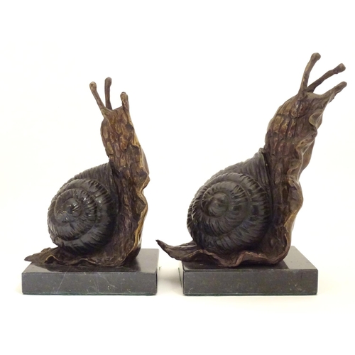 1029 - A pair of 20thC cast bronze bookends modelled as snails, each on a rectangular marble base. Approx. ... 