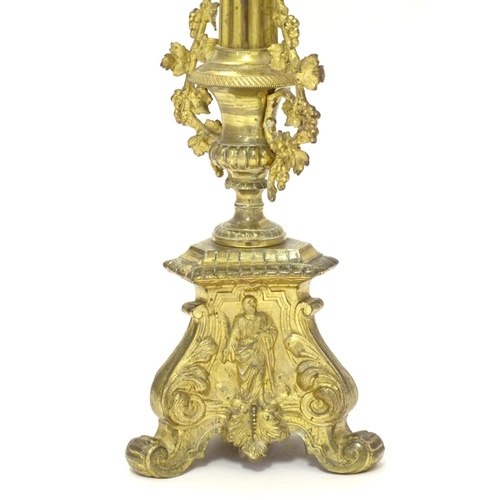 1031 - A 20thC large ecclesiastical gilded pricket candlestick with a fluted column flanked by applied vine... 